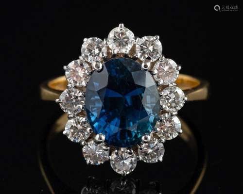 An 18ct gold, sapphire and diamond cluster ring,: the sapphi...