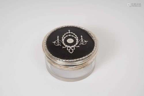 A silver and tortoiseshell topped circular glass jar