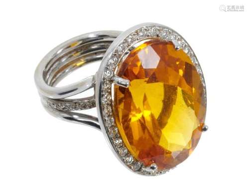 Citrine and diamond cluster ring with a large oval mixed cut...