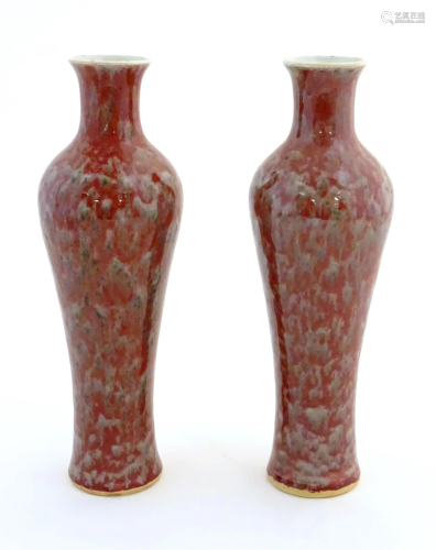 A pair of Chinese vases of elongated form decorated with a m...