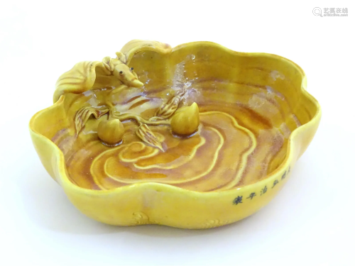 A Chinese fluted edged yellow brush wash dish with relief ba...