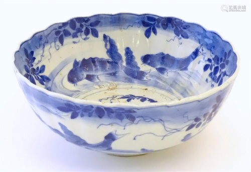 A large Chinese blue and white bowl with a scalloped edge, t...