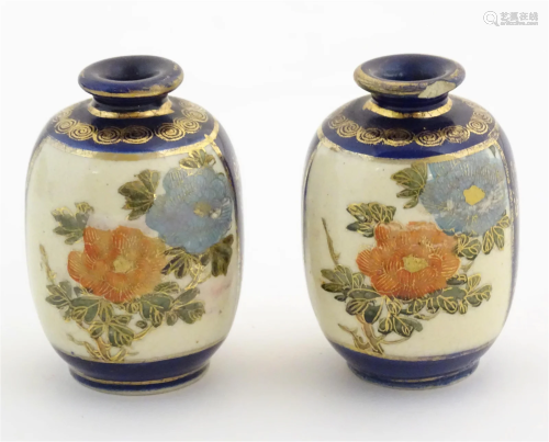A pair of small Japanese vases decorated with flowers and fo...