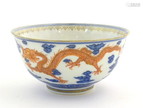 A Chinese blue and white dragon bowl decorated with red drag...
