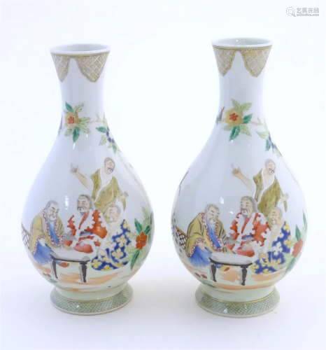 A pair of Chinese famille rose bottle vases decorated with s...