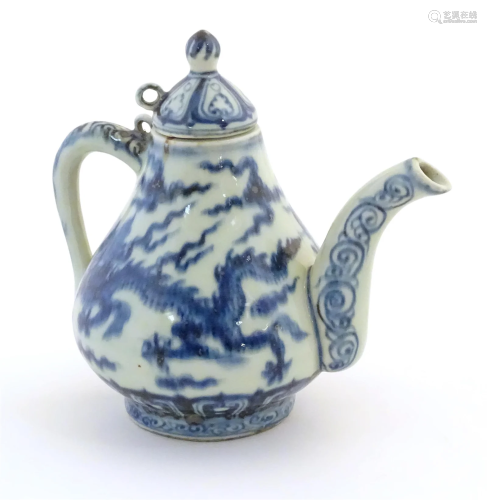 A Chinese blue and white teapot decorated with dragons among...