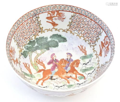 A Chinese bowl decorated with landscape scenes depicting fig...