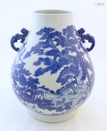 A large Chinese Hu vase with scrolled twin handles, the body...
