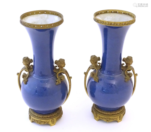 A pair of Oriental bottle vases with flared rims and applied...