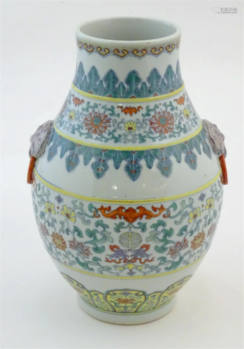 A Chinese famille verte vase with a bulbous body with twin r...