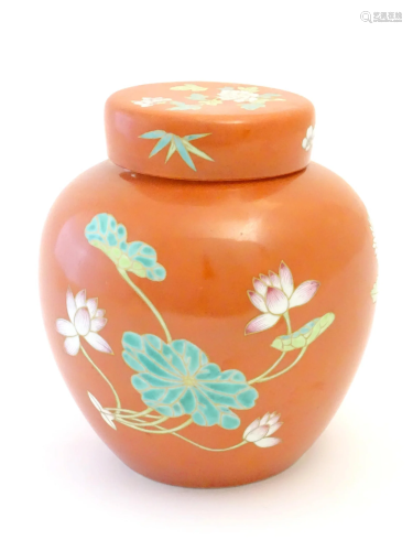 A Chinese ginger jar with an orange ground decorated with fl...