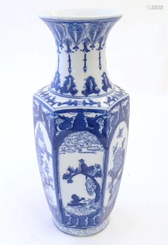 An Oriental blue and white vase with panelled decoration dep...