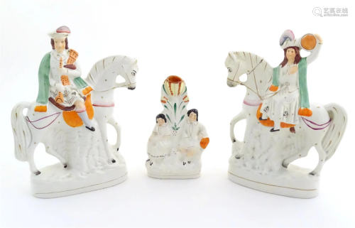 Three Victorian Staffordshire figures depicting male and fem...