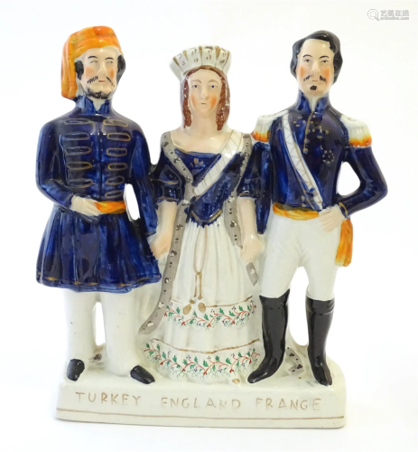 A Victorian Staffordshire pottery flat back figural group Tu...