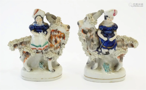 A pair of Victorian Staffordshire pottery figures depicting ...