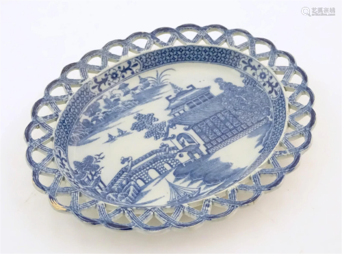A 19thC blue and white dish of oval form with reticulated bo...