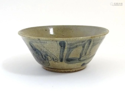 A Chinese crackle glaze bowl with blue brushwork detail. App...