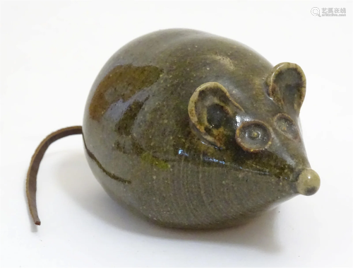 A 20thC studio pottery model of a mouse with a leather tail....