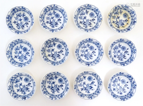 Twelve Continental blue and white saucers with flared rims, ...