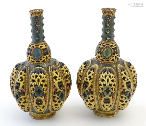 A pair Zsolnay bottle vases with reticulated decoration. Ind...