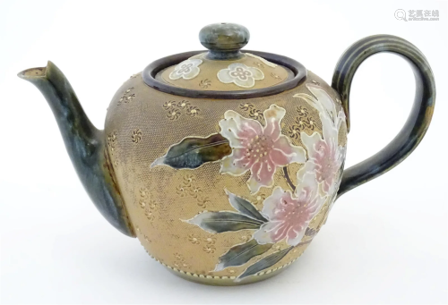 A Royal Doulton stoneware teapot decorated with flowers and ...