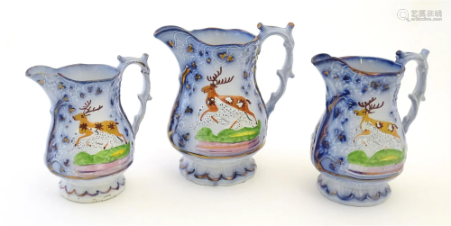 A set of three Victorian graduated jugs with stag / deer dec...