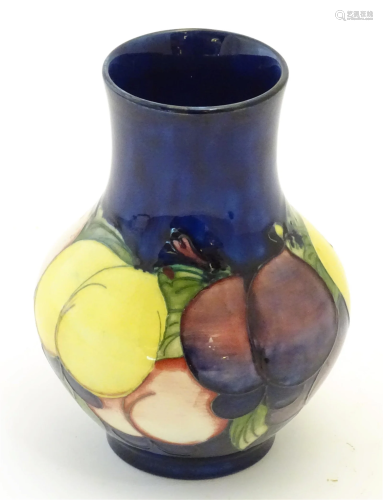 A Moorcroft squat vase in the Wisteria Plum pattern. Marked ...