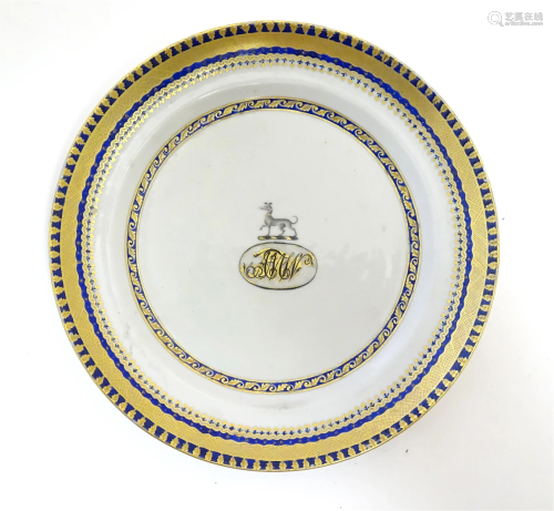 A Chinese Export plate with long dog armorial and monogram u...