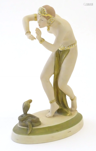 A Royal Dux Art Deco figure modelled as a female snake charm...