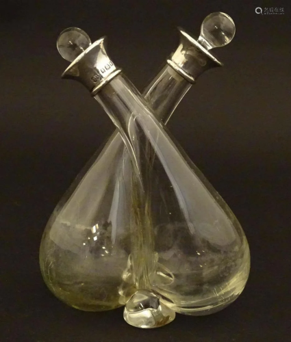 A glass oil and vinegar double cruet bottle with silver coll...
