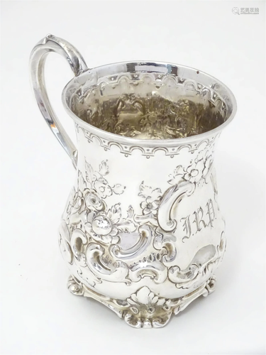 A Victorian silver christening mug with embossed floral and ...