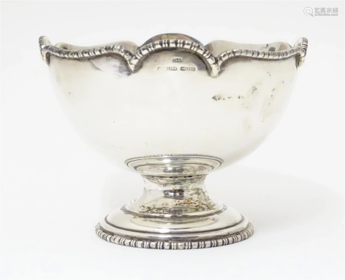 A silver pedestal bowl. Marked Sterling Silver. with indisti...