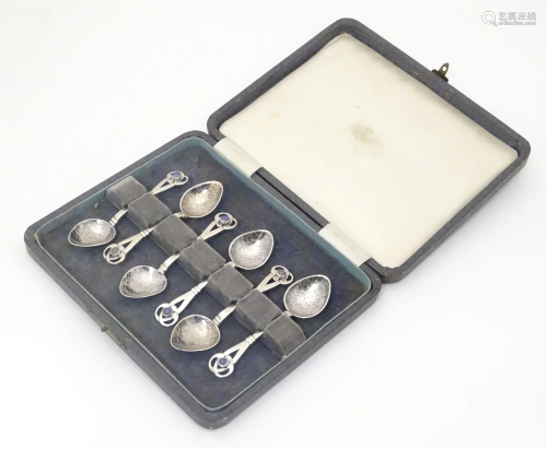 A set of six Arts & Crafts silver tea spoons with hammer...
