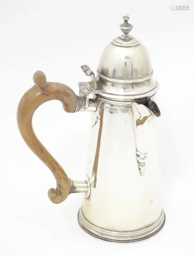 A George V silver coffee / chocolate pot with wooden side ha...