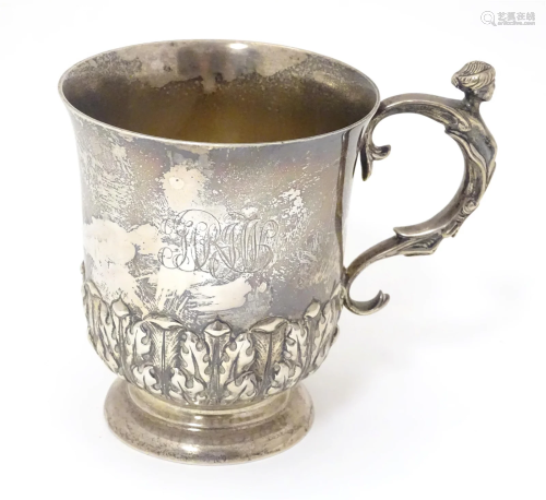 A silver mug with caryatid detail to handle and banded acant...