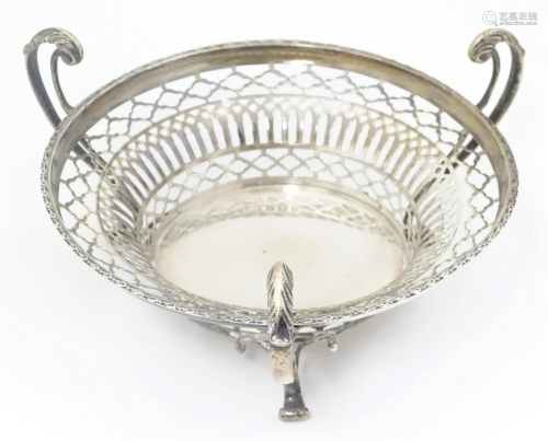 A silver three footed basket with pierced decoration, hallma...
