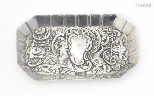 A small Edwardian silver tray with embossed decoration unusu...