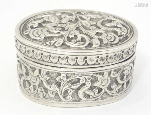 A Continental white metal pot and cover of oval form with em...