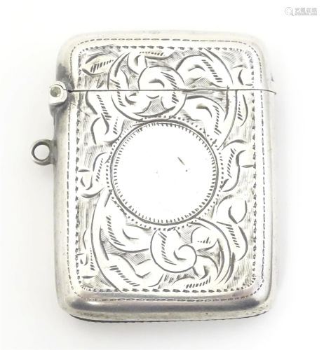 A silver vesta case with engraved acanthus scroll decoration...