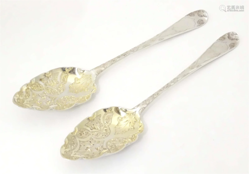 Two silver berry spoons with gilded bowls and engraved detai...