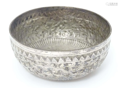 A white metal bowl with acanthus scroll detail, possibly Ind...