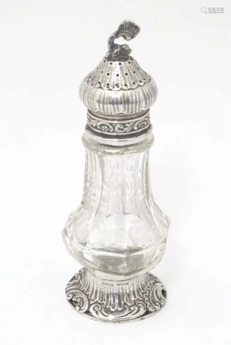 A Continental cut glass pepper pot engraved floral and folia...