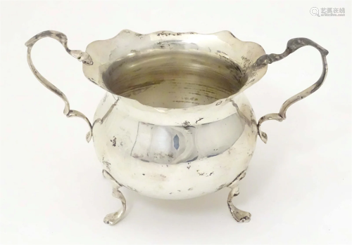 A Victorian silver twin handled sugar bowl on four out swept...
