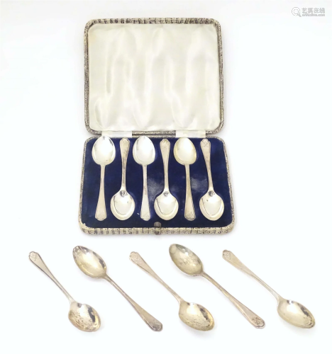 Eleven silver teaspoons with crossed golf clubs and ball dec...