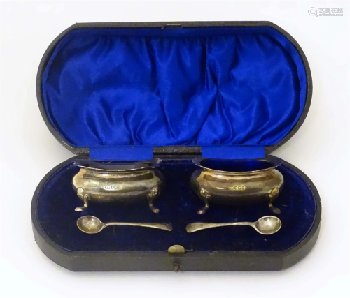 A cased set of silver salts with blue glass liners and salt ...