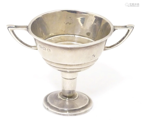 An Art Deco miniature twin handled trophy cup. Hallmarked Bi...