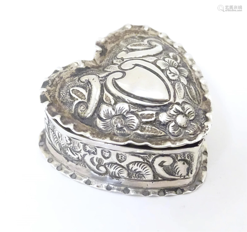 A Victorian silver pill box of heart form with embossed deco...