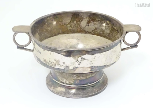 A silver porringer with twin handles hallmarked Sheffield 19...