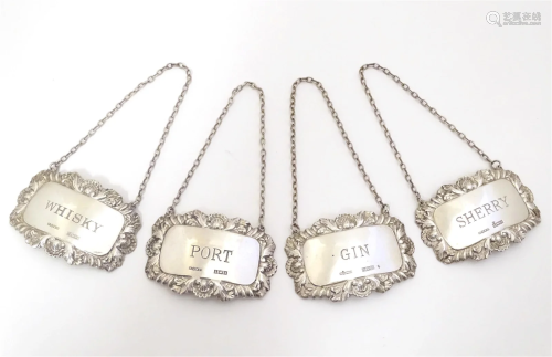 A set of four silver decanter / wine labels / bottle tickets...