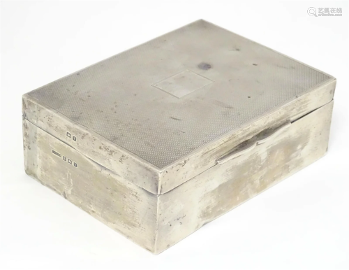 A silver table top cigarette box with engine turned decorati...